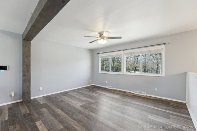 unfurnished room featuring a ceiling fan, visible vents, baseboards, and wood finished floors