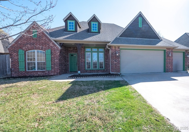 view of front facade with an attached garage, brick siding, roof with shingles, and a front yard