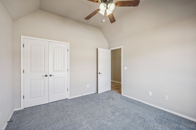 unfurnished bedroom featuring carpet floors, a closet, vaulted ceiling, and ceiling fan