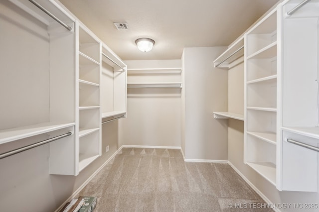 spacious closet with carpet floors and visible vents