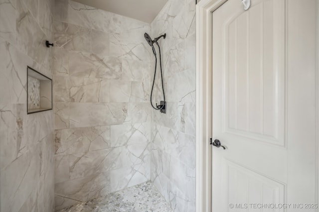 full bathroom with a tile shower