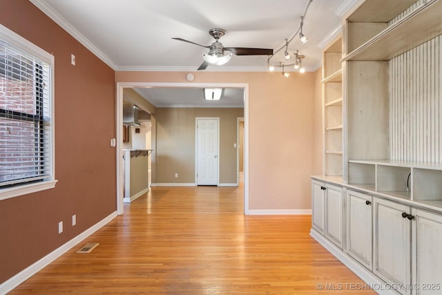 interior space with visible vents, light wood-style floors, ceiling fan, and ornamental molding