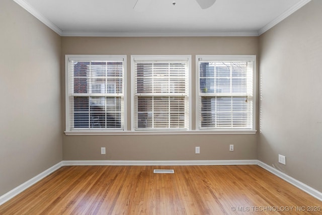 spare room featuring visible vents, baseboards, light wood-type flooring, and ceiling fan