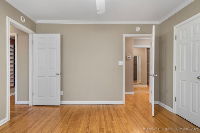 unfurnished bedroom featuring light wood-style flooring, baseboards, and ornamental molding