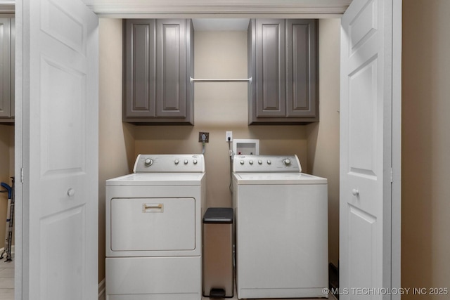 washroom with washer and dryer and cabinet space