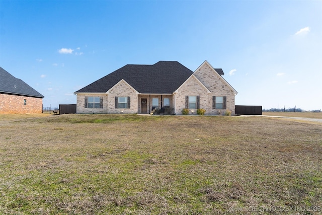 view of front facade featuring a front lawn and brick siding