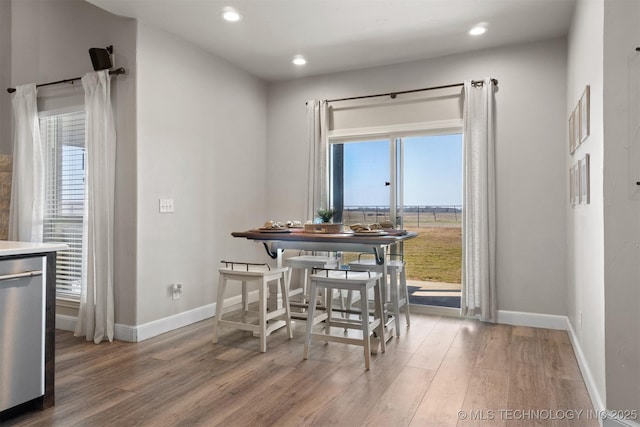 dining area with a healthy amount of sunlight and wood finished floors