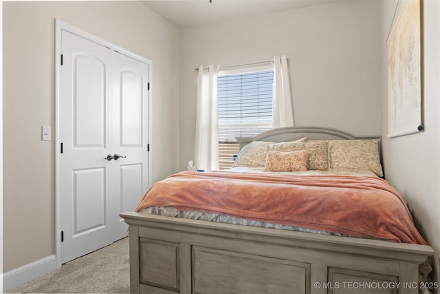 carpeted bedroom featuring baseboards