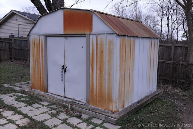 view of shed with a fenced backyard