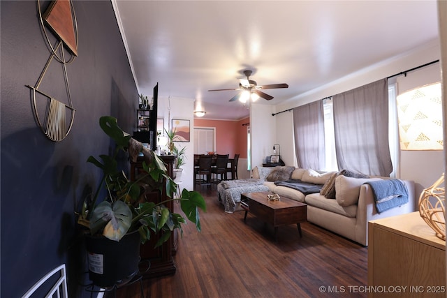 living area with dark wood-type flooring and a ceiling fan