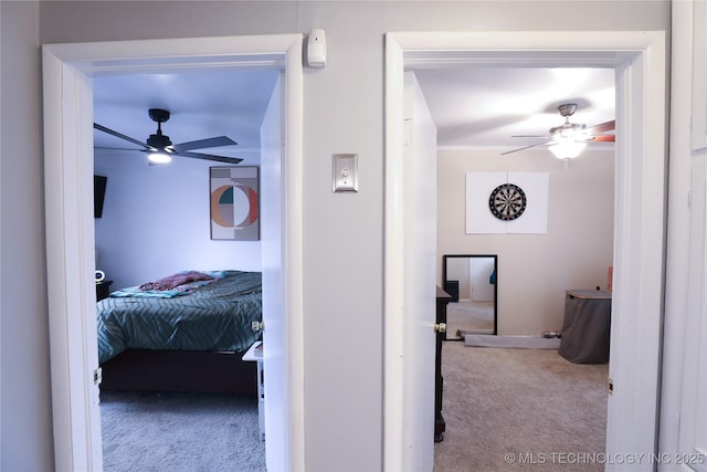 bedroom with ceiling fan, carpet floors, and ornamental molding