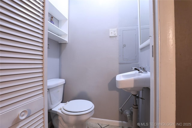 half bath with toilet and electric panel