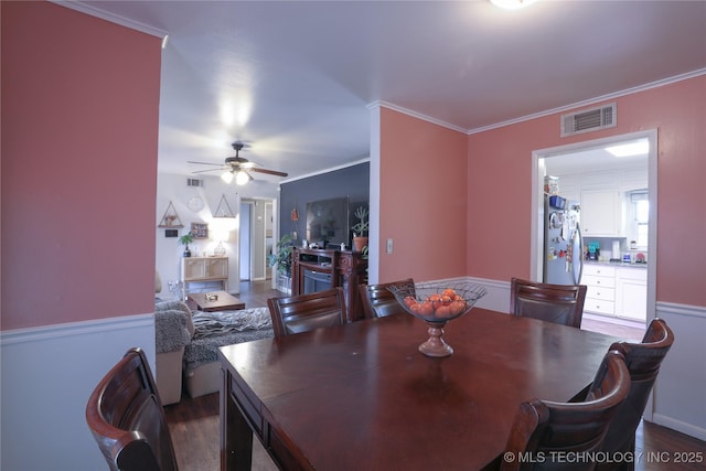 dining room featuring ornamental molding, visible vents, and ceiling fan