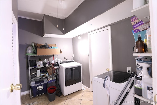 laundry room with laundry area, washer / clothes dryer, and light tile patterned flooring