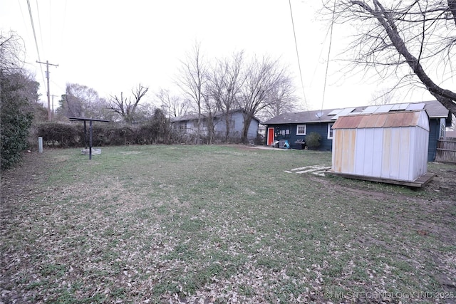 view of yard featuring an outbuilding and a shed