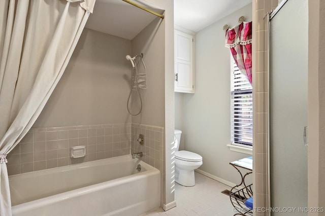 bathroom with shower / bath combination with curtain, toilet, and baseboards