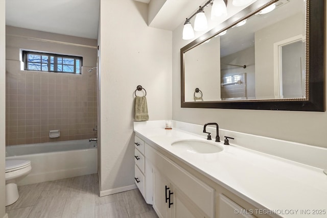 full bathroom featuring baseboards, shower / tub combination, vanity, and toilet