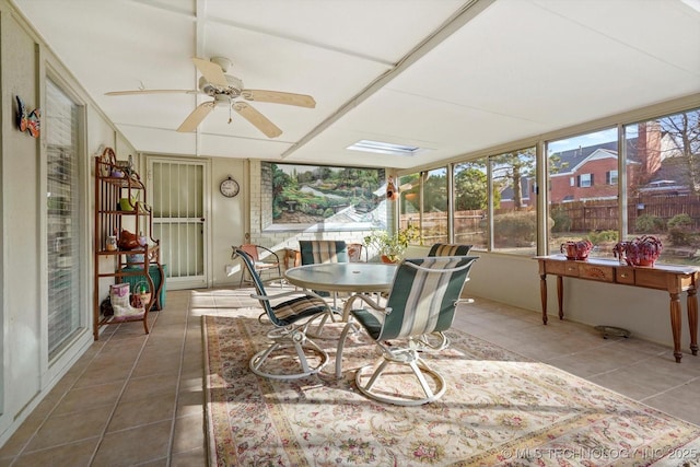 sunroom featuring a ceiling fan