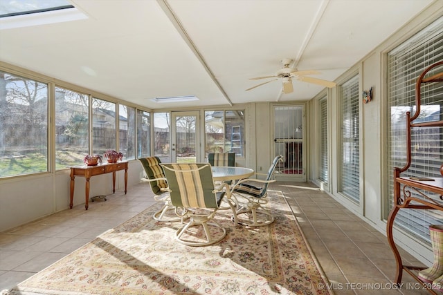 sunroom featuring a ceiling fan