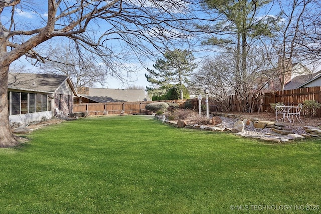 view of yard with a fenced backyard