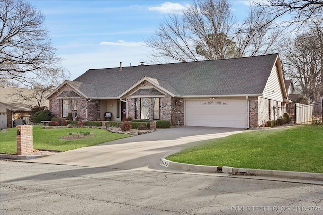 view of front of home with a garage, concrete driveway, fence, a front lawn, and brick siding