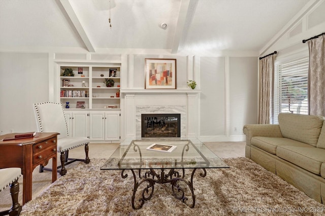 living room featuring light carpet, vaulted ceiling with beams, built in shelves, and a high end fireplace