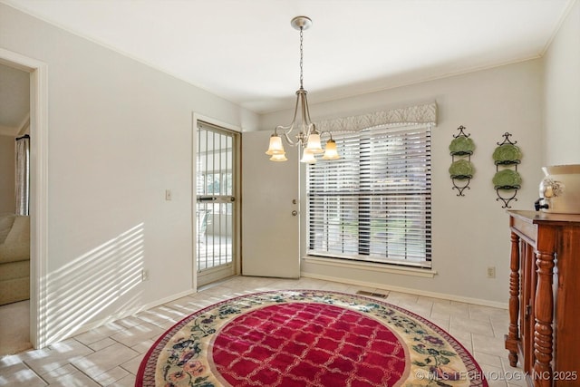 entryway featuring baseboards, visible vents, a notable chandelier, and tile patterned floors