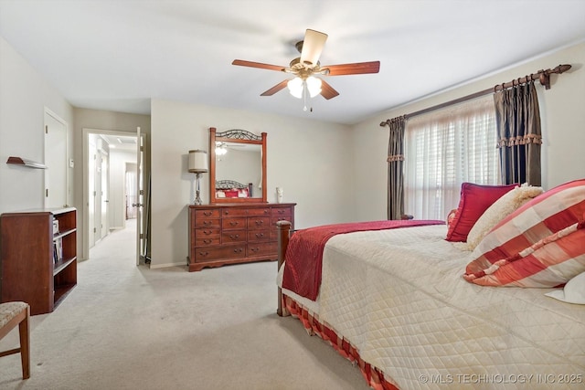 bedroom featuring light carpet and a ceiling fan