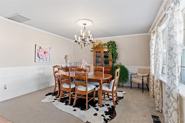 dining area with light colored carpet, visible vents, crown molding, and a notable chandelier