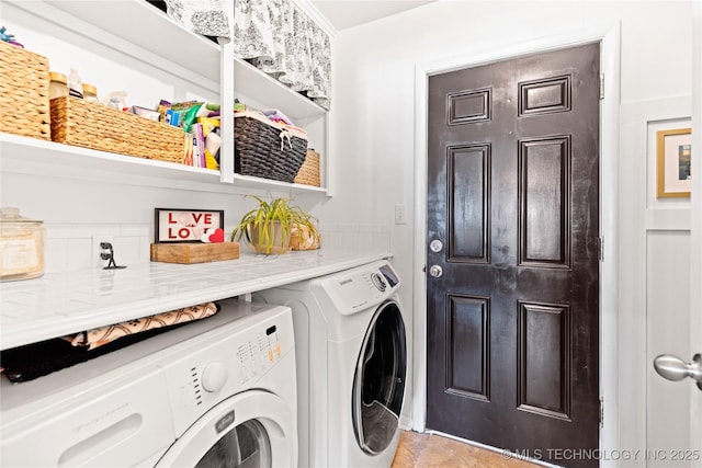 clothes washing area with washer and clothes dryer and laundry area