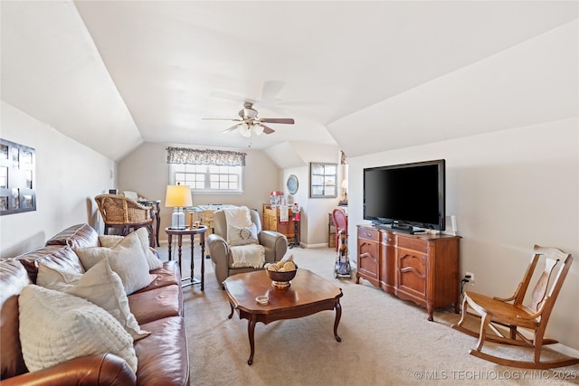 living area featuring a ceiling fan, lofted ceiling, light colored carpet, and baseboards