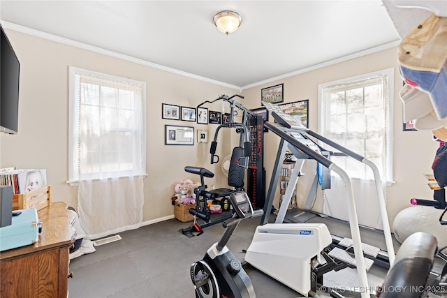 workout area featuring baseboards and crown molding