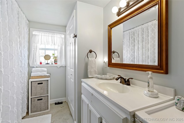 bathroom with vanity and baseboards