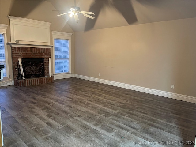 unfurnished living room with dark wood-type flooring, baseboards, a brick fireplace, ceiling fan, and vaulted ceiling