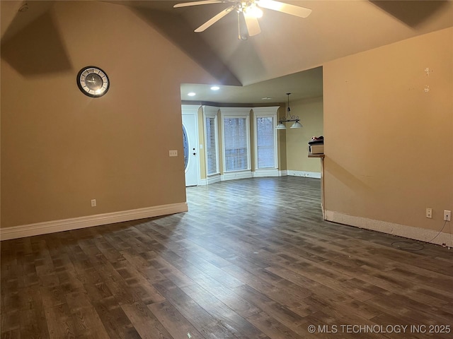 unfurnished living room with high vaulted ceiling, dark wood-style floors, baseboards, and ceiling fan