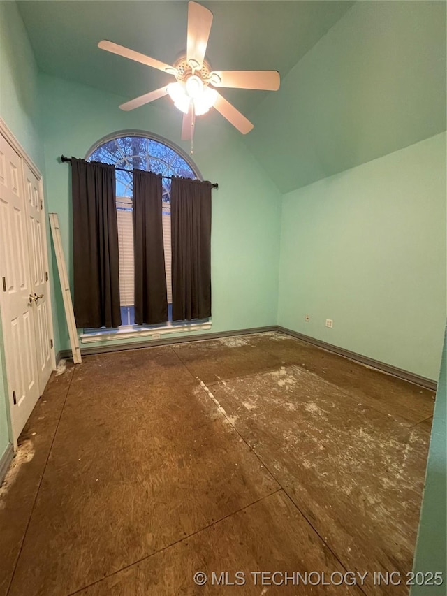 additional living space featuring baseboards, lofted ceiling, and a ceiling fan