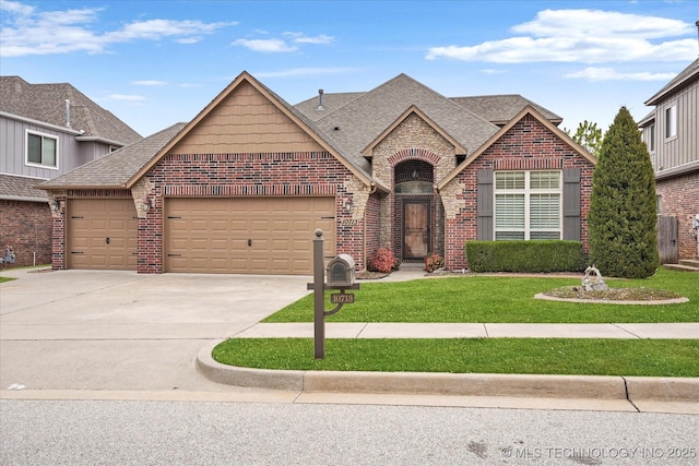 view of front of house featuring a front lawn, concrete driveway, an attached garage, a shingled roof, and brick siding