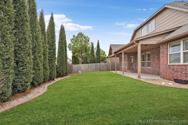 view of yard featuring fence and a patio area