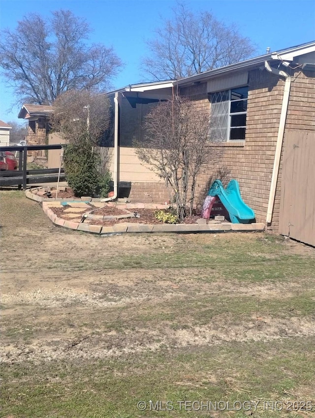 view of side of property with brick siding