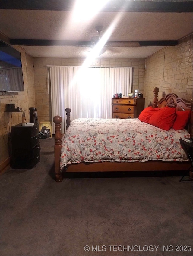 bedroom with beamed ceiling, ceiling fan, and carpet