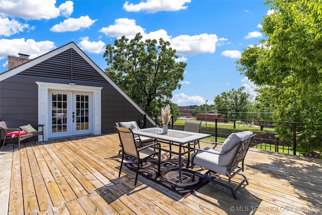 deck with outdoor dining space and french doors