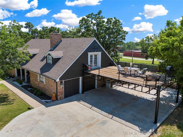 view of front of home featuring fence, roof with shingles, a chimney, french doors, and brick siding