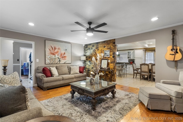 living area with recessed lighting, crown molding, ceiling fan, and wood finished floors