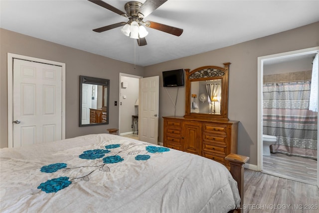 bedroom featuring connected bathroom, baseboards, light wood-style floors, and ceiling fan