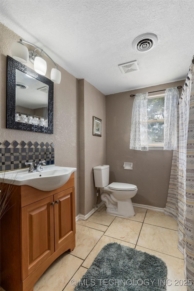 full bathroom featuring tile patterned floors, visible vents, a textured ceiling, and toilet