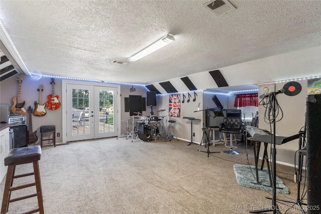 game room featuring visible vents, carpet floors, vaulted ceiling, french doors, and a textured ceiling