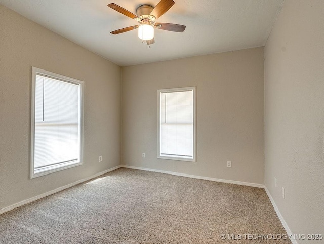 carpeted empty room with plenty of natural light, baseboards, and ceiling fan