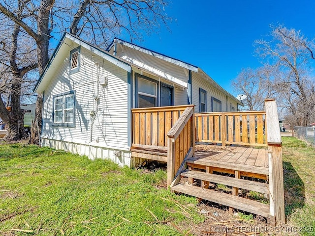 back of property featuring a wooden deck