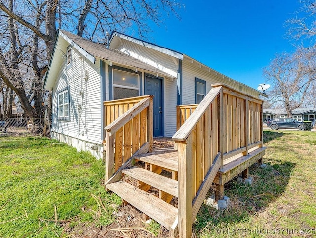 exterior space featuring a lawn and a deck