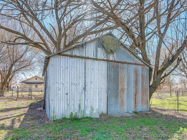 view of pole building featuring fence